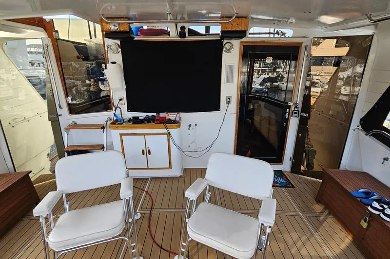 Outbound Yacht Photos Pics Interior of 1993 Symbol 55 Yachtfisher with chairs and equipment on deck.