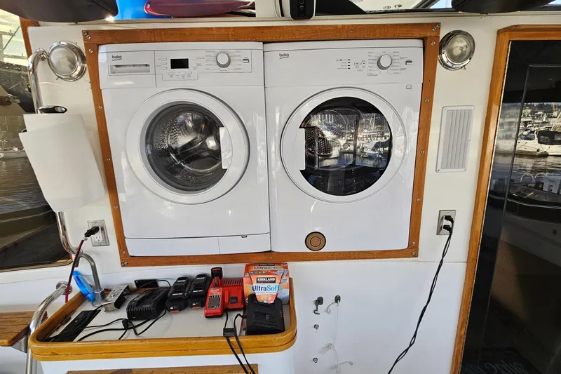 Outbound Yacht Photos Pics Laundry area on 1993 Symbol 55 Yachtfisher with washer, dryer, and charging station.