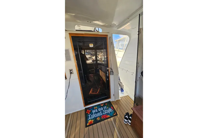 Outbound Yacht Photos Pics Entrance of 1993 Symbol 55 Yachtfisher with "We Do It Island Style" mat.