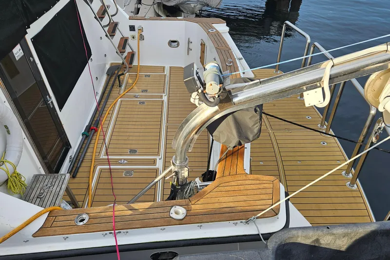 Outbound Yacht Photos Pics 1993 Symbol 55 Yachtfisher with teak deck, docked at marina.