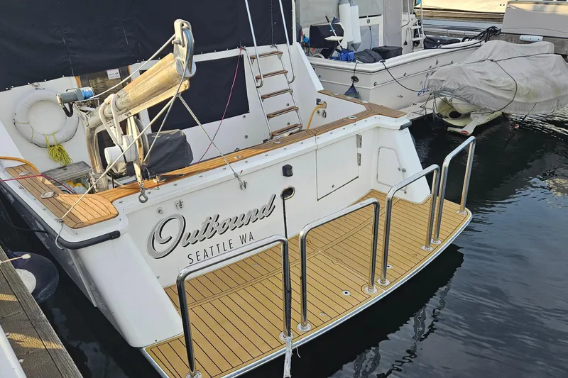 Outbound Yacht Photos Pics 1993 Symbol 55 Yachtfisher docked, featuring wooden deck and "Outbound Seattle WA" text.