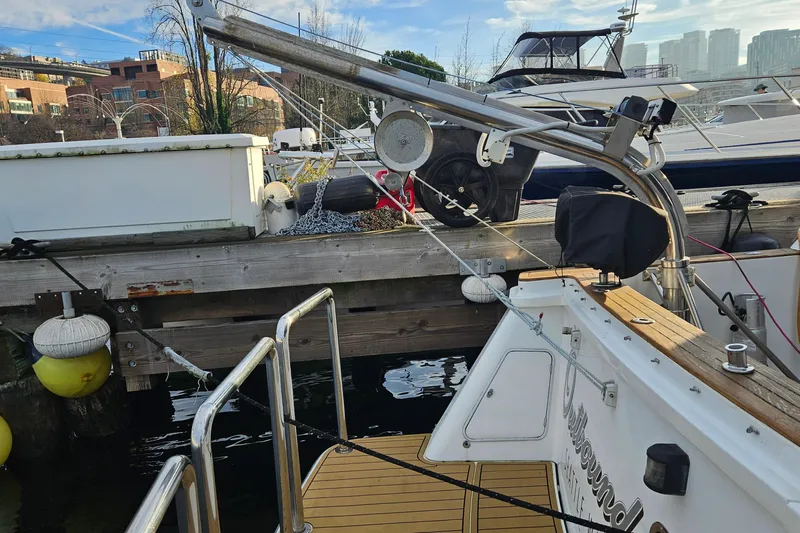 Outbound Yacht Photos Pics 1993 Symbol 55 Yachtfisher docked, showcasing deck and marina surroundings.