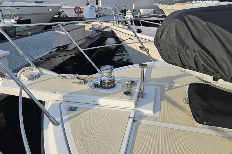 Outbound Yacht Photos Pics 1993 Symbol 55 Yachtfisher deck with winch and covered seating at marina.
