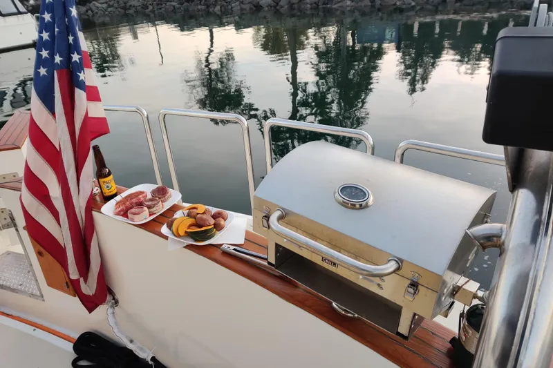 Outbound Yacht Photos Pics Outdoor grill setup on 1993 Symbol 55 Yachtfisher with food and American flag.