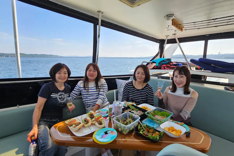 Outbound Yacht Photos Pics Women enjoying a meal on a 1993 Symbol 55 Yachtfisher, with ocean views.