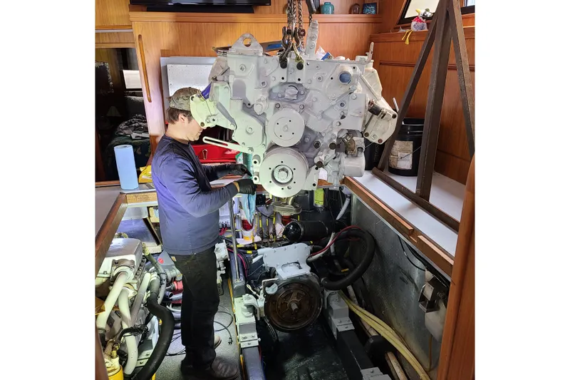 Outbound Yacht Photos Pics Mechanic working on engine inside 1993 Symbol 55 Yachtfisher boat.