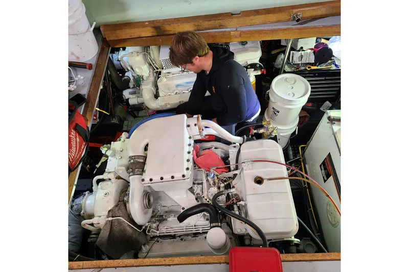 Outbound Yacht Photos Pics Person working on engine in 1993 Symbol 55 Yachtfisher boat.