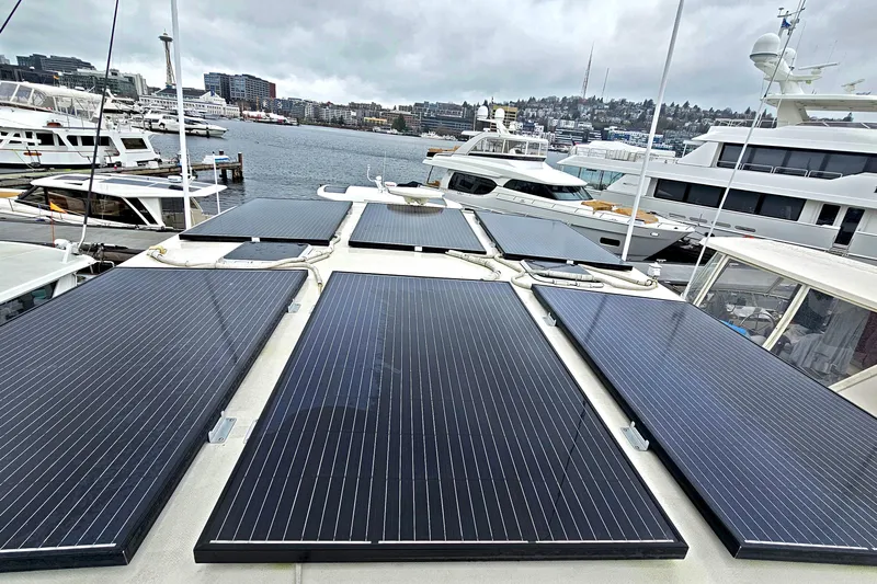 Outbound Yacht Photos Pics Solar panels on 1993 Symbol 55 Yachtfisher docked in a marina with cityscape background.