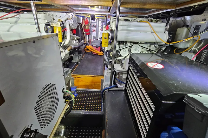 Outbound Yacht Photos Pics Engine room of a 1993 Symbol Yacht Fisher/Motor Yacht with visible machinery and equipment.