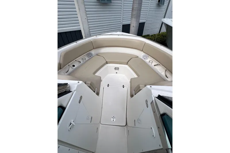  Yacht Photos Pics 2016 Pursuit DC 325 Dual Console boat interior with beige seating and storage compartments.