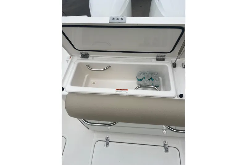  Yacht Photos Pics Open storage compartment on 2016 Pursuit DC 325 Dual Console boat with water bottles inside.