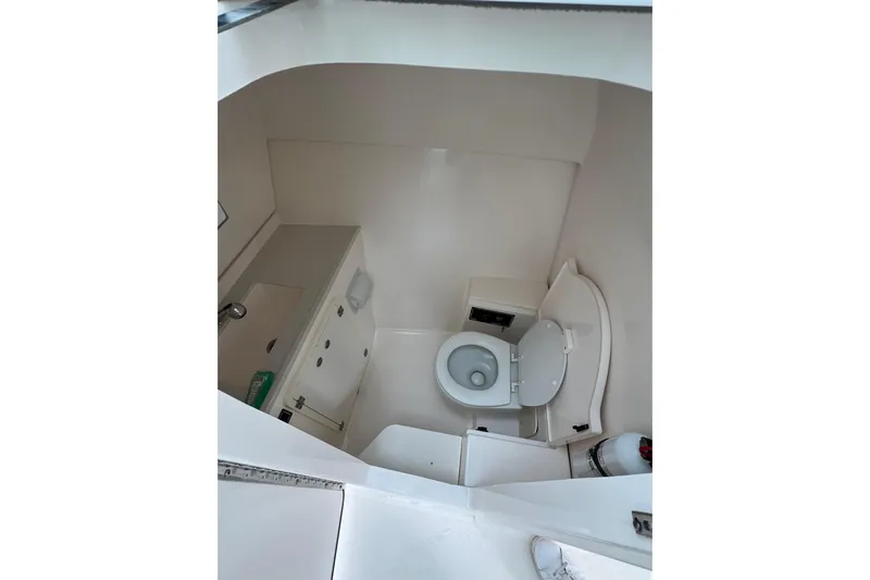  Yacht Photos Pics 2016 Pursuit DC 325 Dual Console boat interior with compact bathroom amenities.