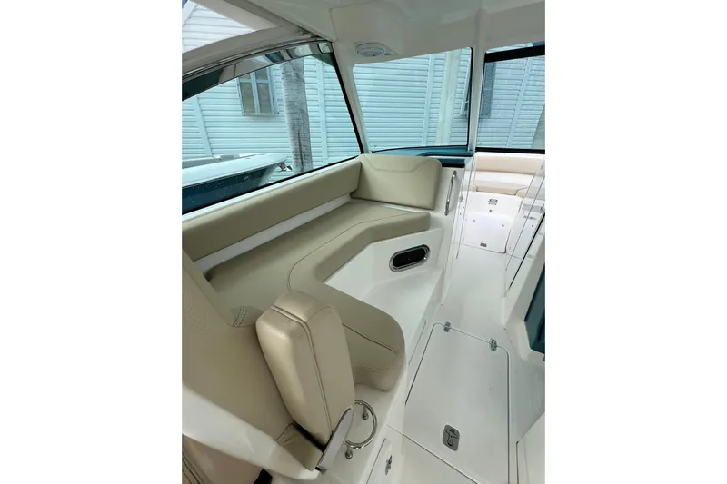  Yacht Photos Pics 2016 Pursuit DC 325 Dual Console interior with beige seating and sleek design.