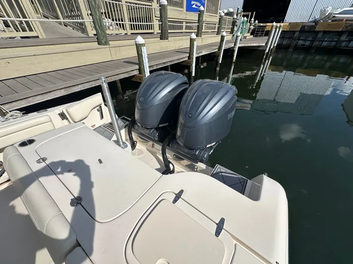  Yacht Photos Pics 2022 Grady-White Freedom 285 boat with dual outboard engines docked at marina.