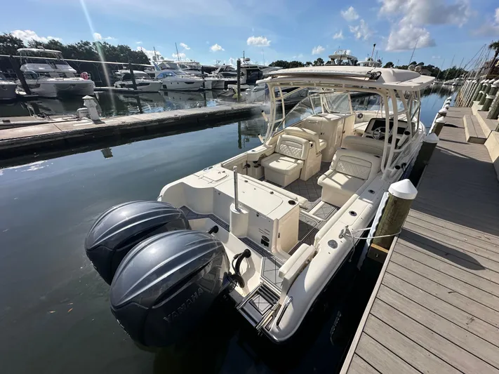  Yacht Photos Pics 2022 Grady-White Freedom 285 boat docked with dual Yamaha engines, sunny marina setting.