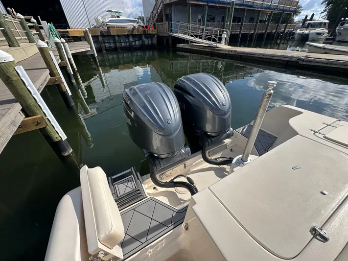  Yacht Photos Pics 2022 Grady-White Freedom 285 boat with dual outboard engines docked at marina.
