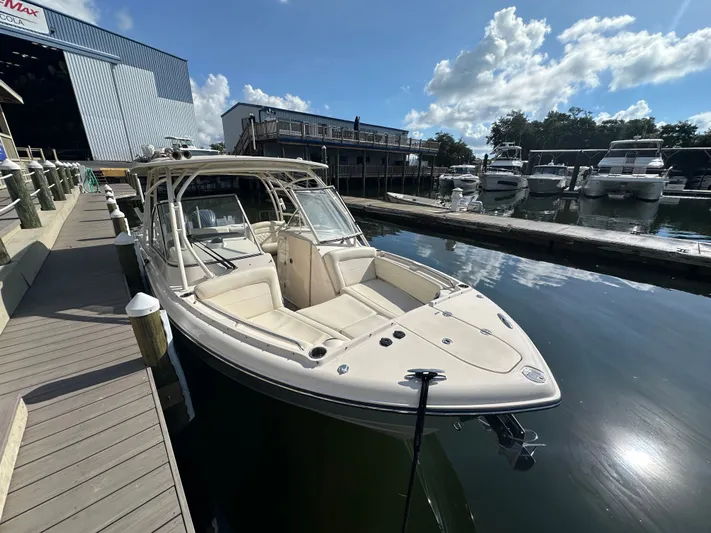  Yacht Photos Pics 2022 Grady-White Freedom 285 boat docked at marina under blue sky.