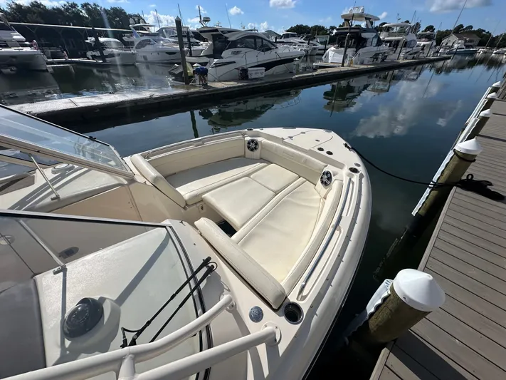  Yacht Photos Pics 2022 Grady-White Freedom 285 boat docked at marina, featuring spacious seating and sleek design.
