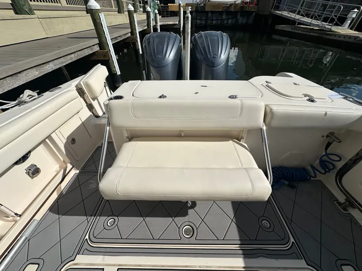  Yacht Photos Pics 2022 Grady-White Freedom 285 boat interior with seating and dual outboard motors.