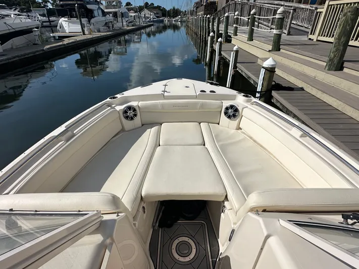  Yacht Photos Pics 2022 Grady-White Freedom 285 boat interior with white seating at a marina dock.