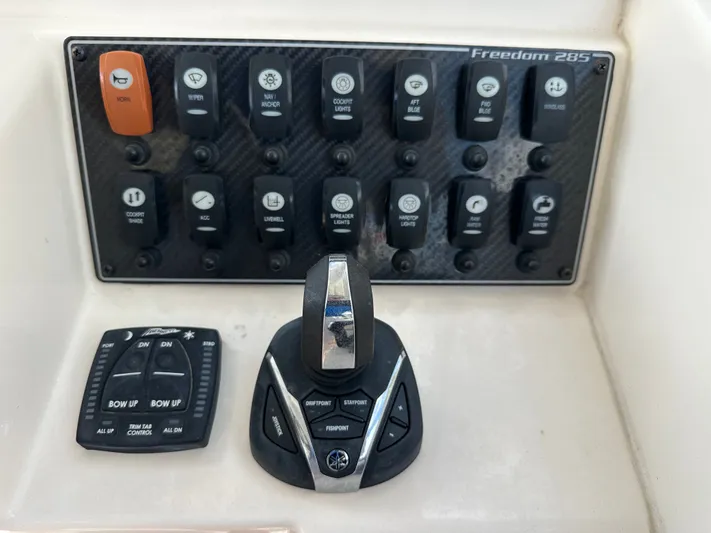  Yacht Photos Pics Control panel of 2022 Grady-White Freedom 285 boat with various switches and joystick.