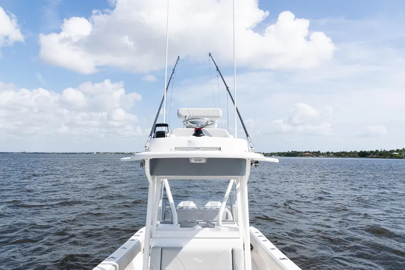  Yacht Photos Pics 2024 SeaVee 290B boat on open water under a partly cloudy sky.