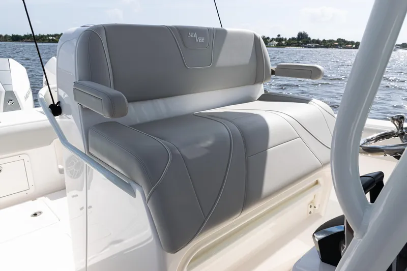  Yacht Photos Pics 2024 SeaVee 290B boat with gray cushioned seating, on a sunny day at sea.