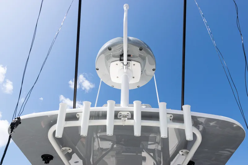  Yacht Photos Pics 2024 SeaVee 290B boat with radar and rod holders against a clear blue sky.