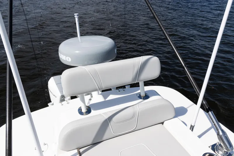  Yacht Photos Pics 2024 SeaVee 290B boat with cushioned seating and radar, on calm water.