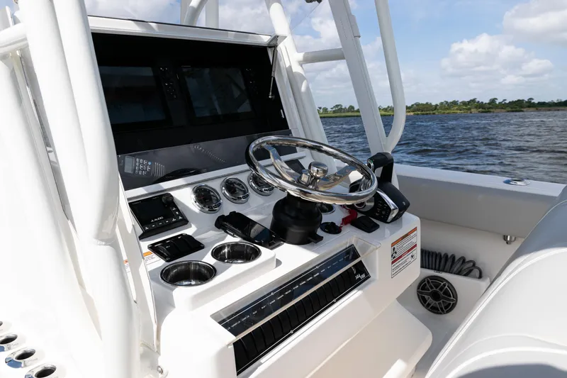  Yacht Photos Pics 2024 SeaVee 290B boat console with steering wheel and controls on open water.