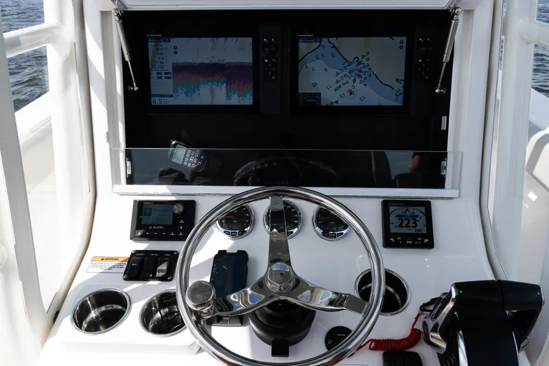  Yacht Photos Pics 2024 SeaVee 290B helm with dual displays, steering wheel, and navigation controls.