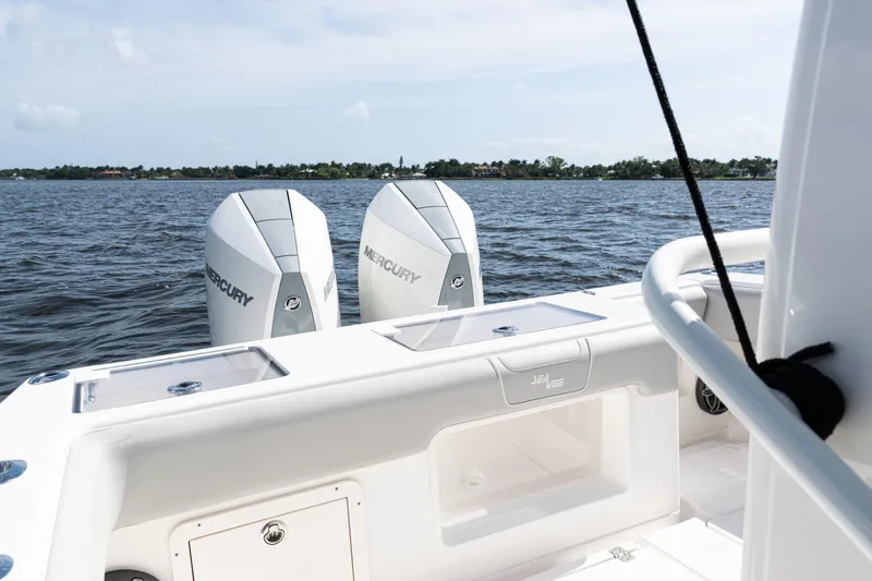  Yacht Photos Pics 2024 SeaVee 290B boat with dual Mercury engines on a calm water backdrop.