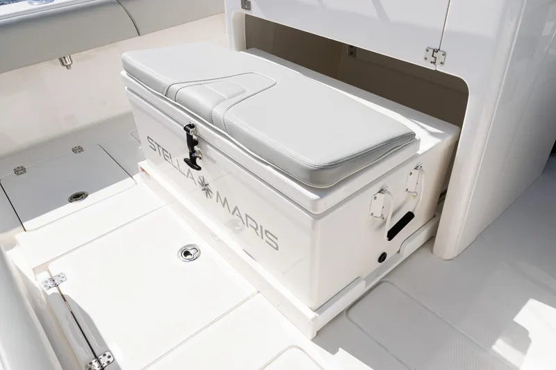  Yacht Photos Pics 2024 SeaVee 290B boat interior with cushioned storage bench labeled "Stella Maris."