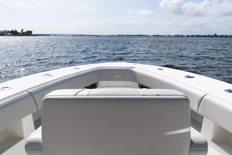  Yacht Photos Pics 2024 SeaVee 290B boat on calm waters under a partly cloudy sky.