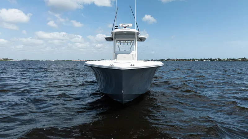  Yacht Photos Pics 2024 SeaVee 290B boat on open water under a clear blue sky.