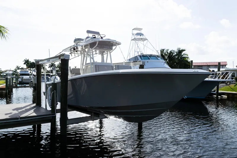  Yacht Photos Pics 2024 SeaVee 290B boat docked in a marina, showcasing sleek design and modern features.