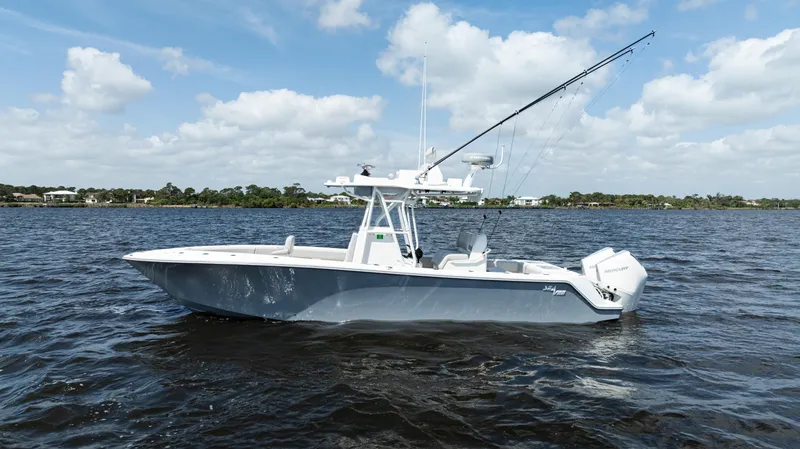  Yacht Photos Pics 2024 SeaVee 290B boat on open water under a partly cloudy sky.