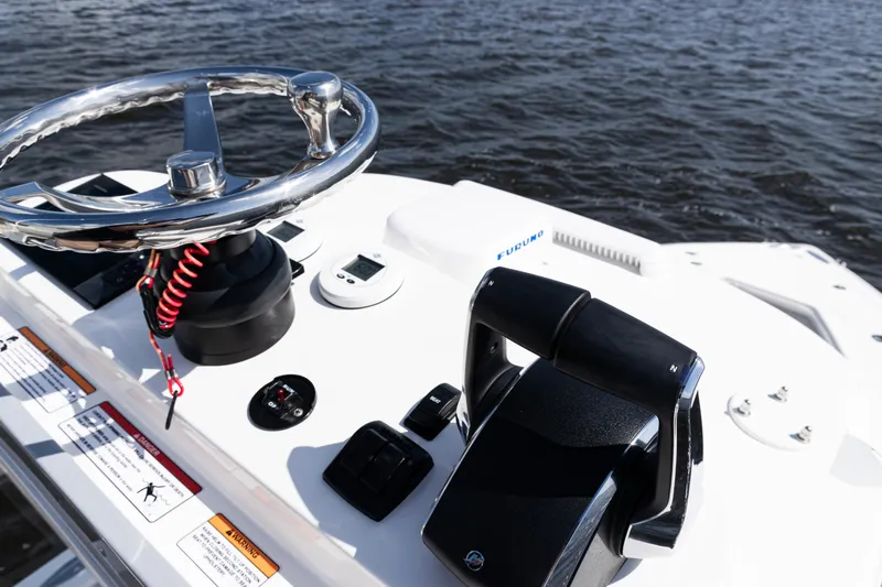  Yacht Photos Pics 2024 SeaVee 290B boat helm with steering wheel and controls on water.