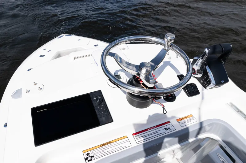  Yacht Photos Pics 2024 SeaVee 290B boat helm with steering wheel and navigation display.