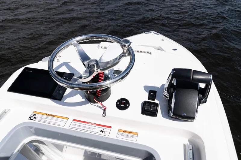  Yacht Photos Pics 2024 SeaVee 290B boat helm with steering wheel and controls on open water.