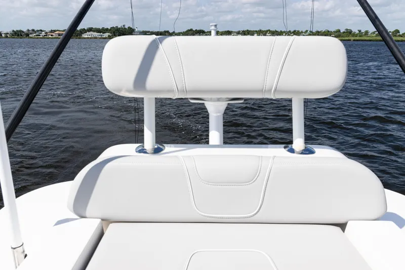  Yacht Photos Pics 2024 SeaVee 290B boat with white seating, on calm water.