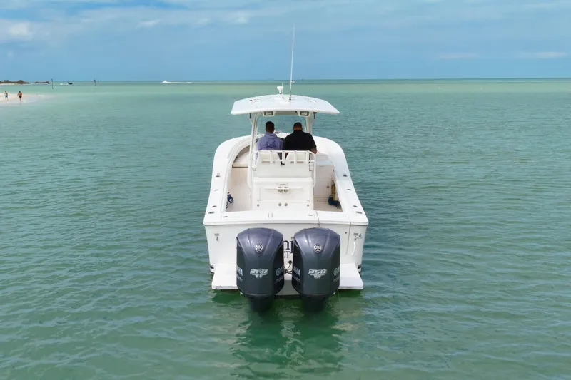 Redemption Yacht Photos Pics 2012 Regulator 34SS boat with dual engines on calm turquoise water.