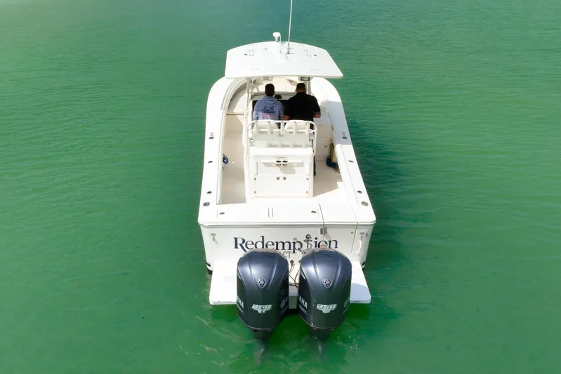 Redemption Yacht Photos Pics 2012 Regulator 34SS boat with dual Yamaha engines on turquoise water.