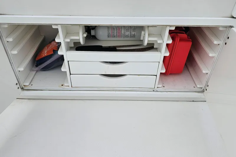 Redemption Yacht Photos Pics Storage compartment on a 2012 Regulator 34SS boat with drawers and safety equipment.