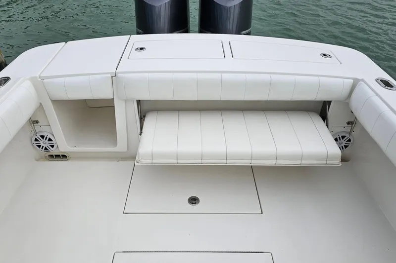 Redemption Yacht Photos Pics 2012 Regulator 34SS boat with white cushioned seating and storage compartments.