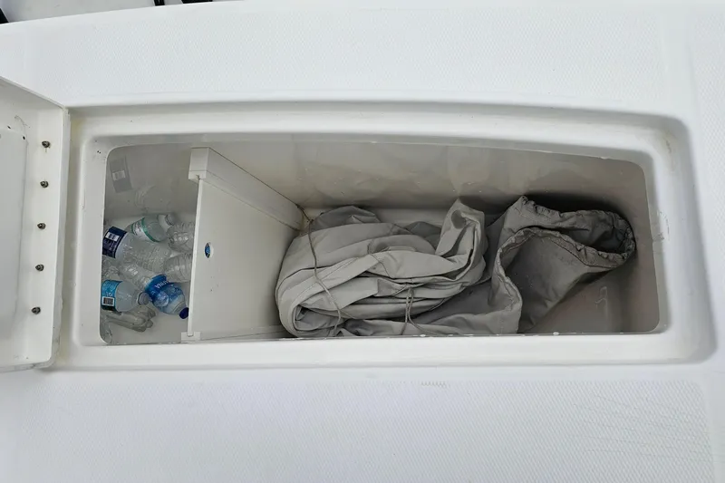 Redemption Yacht Photos Pics Storage compartment on 2012 Regulator 34SS boat with water bottles and tarp.