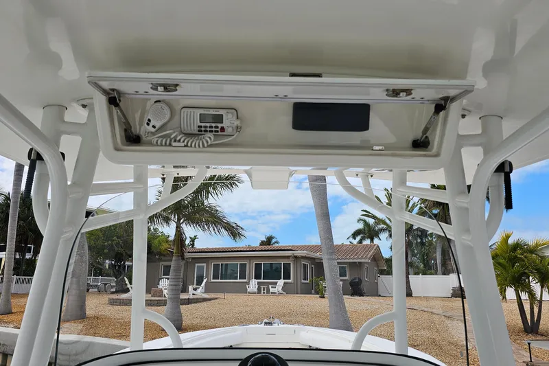 Redemption Yacht Photos Pics 2012 Regulator 34SS boat console with radio, palm trees, and house in background.