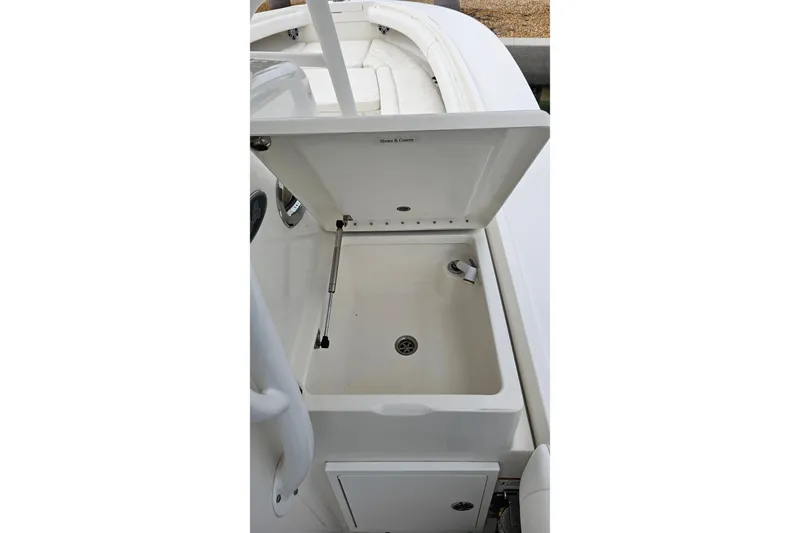 Redemption Yacht Photos Pics 2012 Regulator 34SS boat sink with open lid, showcasing storage and faucet.