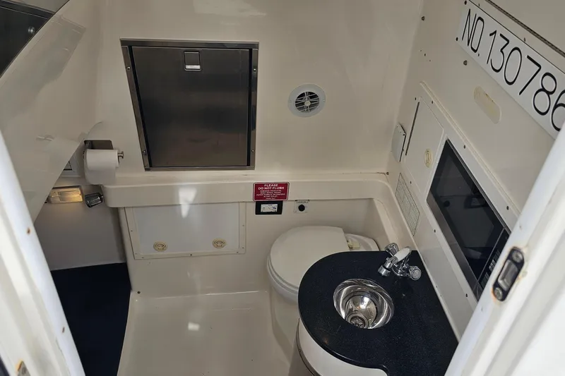 Redemption Yacht Photos Pics 2012 Regulator 34SS boat interior with compact bathroom and sink.