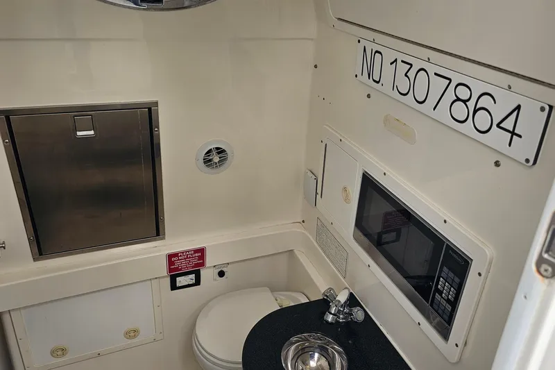 Redemption Yacht Photos Pics 2012 Regulator 34SS boat interior with sink, microwave, and storage.